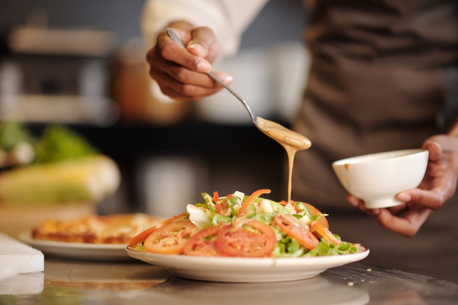 Chef Pouring Dressing over Salad