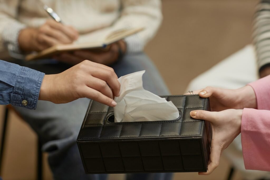 Person taking tissue close up