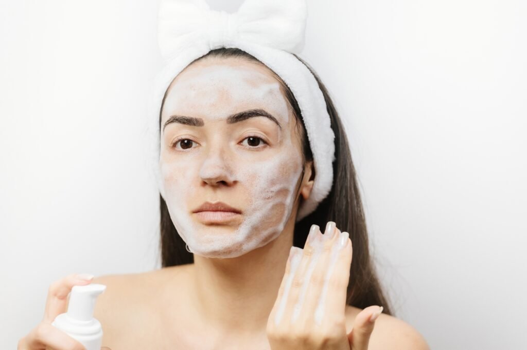 woman applying Facial Cleanser